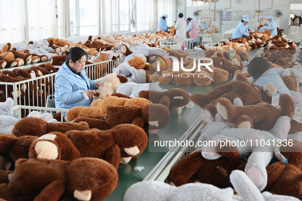 Workers at a toy export enterprise are producing plush toys for export in Lianyungang, China, on March 2, 2024. 