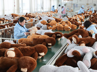 Workers at a toy export enterprise are producing plush toys for export in Lianyungang, China, on March 2, 2024. (