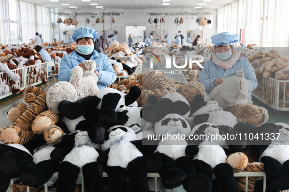 Workers at a toy export enterprise are producing plush toys for export in Lianyungang, China, on March 2, 2024. 