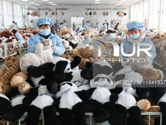 Workers at a toy export enterprise are producing plush toys for export in Lianyungang, China, on March 2, 2024. (