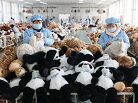 Workers at a toy export enterprise are producing plush toys for export in Lianyungang, China, on March 2, 2024. (