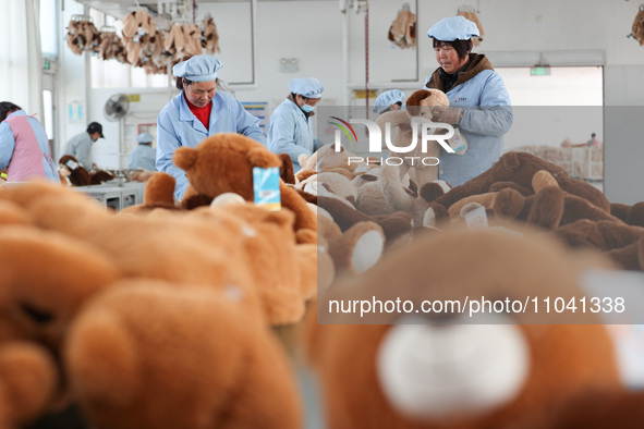 Workers at a toy export enterprise are producing plush toys for export in Lianyungang, China, on March 2, 2024. 