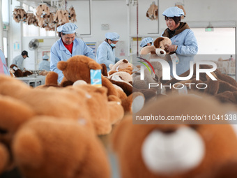 Workers at a toy export enterprise are producing plush toys for export in Lianyungang, China, on March 2, 2024. (