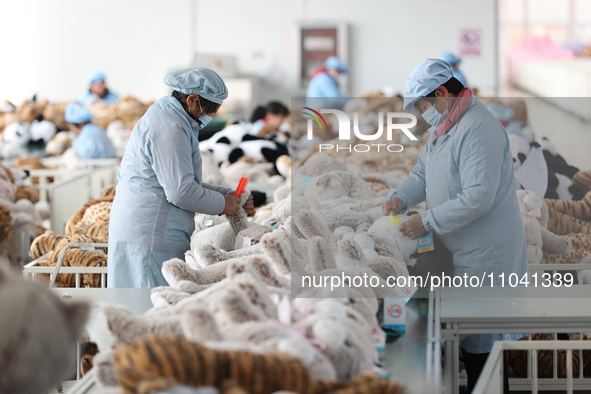 Workers at a toy export enterprise are producing plush toys for export in Lianyungang, China, on March 2, 2024. 