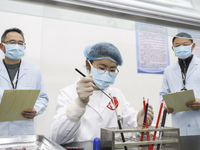 College students are taking part in a microbiology test competition in Huai'an, China, on March 2, 2024. (