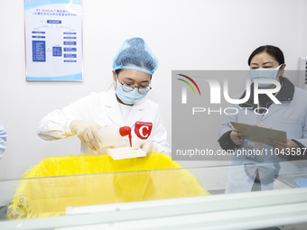 College students are participating in a biochemistry and immunology test competition in Huai'an, China, on March 2, 2024. (