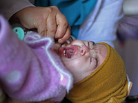 A health worker is administering polio vaccine drops to a child in Srinagar, Kashmir, India, on March 3, 2024. A three-day pulse polio vacci...