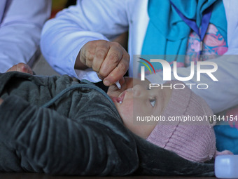 A health worker is administering polio vaccine drops to a child in Srinagar, Kashmir, India, on March 3, 2024. A three-day pulse polio vacci...