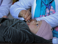 A health worker is administering polio vaccine drops to a child in Srinagar, Kashmir, India, on March 3, 2024. A three-day pulse polio vacci...