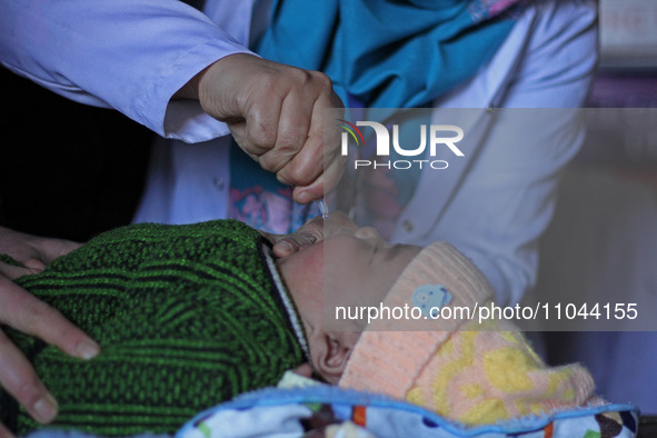 A health worker is administering polio vaccine drops to a child in Srinagar, Kashmir, India, on March 3, 2024. A three-day pulse polio vacci...