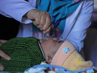 A health worker is administering polio vaccine drops to a child in Srinagar, Kashmir, India, on March 3, 2024. A three-day pulse polio vacci...