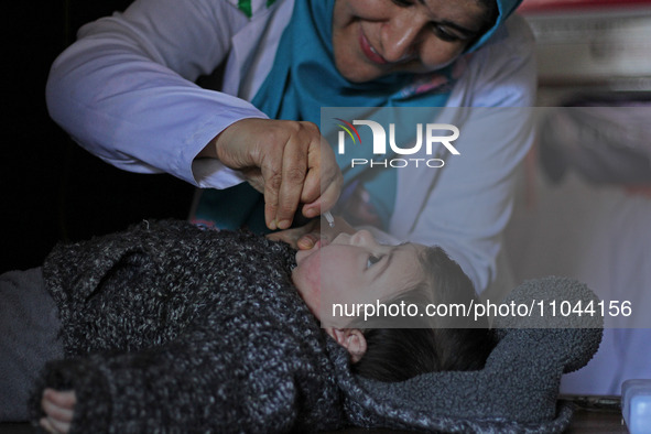 A health worker is administering polio vaccine drops to a child in Srinagar, Kashmir, India, on March 3, 2024. A three-day pulse polio vacci...