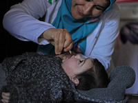 A health worker is administering polio vaccine drops to a child in Srinagar, Kashmir, India, on March 3, 2024. A three-day pulse polio vacci...