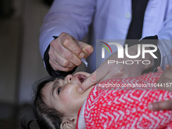 A health worker is administering polio vaccine drops to a child in Srinagar, Kashmir, India, on March 3, 2024. A three-day pulse polio vacci...