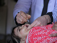 A health worker is administering polio vaccine drops to a child in Srinagar, Kashmir, India, on March 3, 2024. A three-day pulse polio vacci...