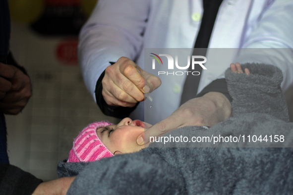 A health worker is administering polio vaccine drops to a child in Srinagar, Kashmir, India, on March 3, 2024. A three-day pulse polio vacci...