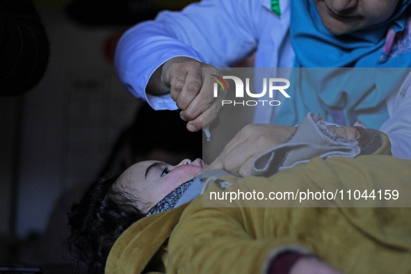 A health worker is administering polio vaccine drops to a child in Srinagar, Kashmir, India, on March 3, 2024. A three-day pulse polio vacci...