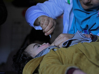 A health worker is administering polio vaccine drops to a child in Srinagar, Kashmir, India, on March 3, 2024. A three-day pulse polio vacci...