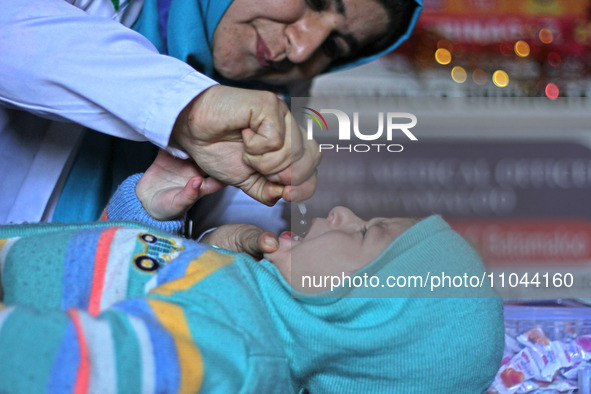 A health worker is administering polio vaccine drops to a child in Srinagar, Kashmir, India, on March 3, 2024. A three-day pulse polio vacci...