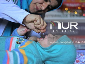 A health worker is administering polio vaccine drops to a child in Srinagar, Kashmir, India, on March 3, 2024. A three-day pulse polio vacci...