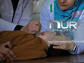 A health worker is administering polio vaccine drops to a child in Srinagar, Kashmir, India, on March 3, 2024. A three-day pulse polio vacci...