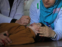 A health worker is administering polio vaccine drops to a child in Srinagar, Kashmir, India, on March 3, 2024. A three-day pulse polio vacci...