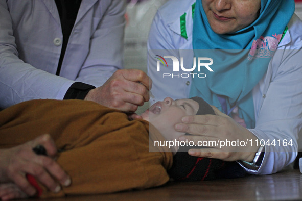 A health worker is administering polio vaccine drops to a child in Srinagar, Kashmir, India, on March 3, 2024. A three-day pulse polio vacci...