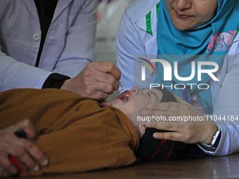 A health worker is administering polio vaccine drops to a child in Srinagar, Kashmir, India, on March 3, 2024. A three-day pulse polio vacci...