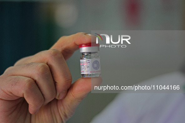 A health worker is showing a vial of polio vaccine at a health center in Srinagar, Kashmir, India, on March 3, 2024. A three-day pulse polio...