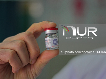 A health worker is showing a vial of polio vaccine at a health center in Srinagar, Kashmir, India, on March 3, 2024. A three-day pulse polio...