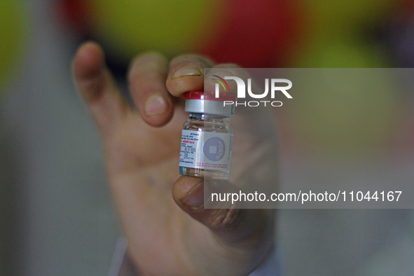 A health worker is showing a vial of polio vaccine at a health center in Srinagar, Kashmir, India, on March 3, 2024. A three-day pulse polio...