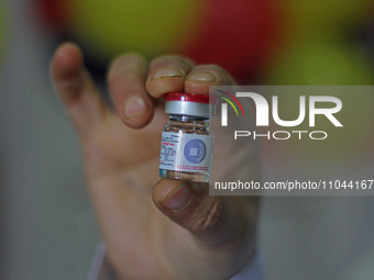 A health worker is showing a vial of polio vaccine at a health center in Srinagar, Kashmir, India, on March 3, 2024. A three-day pulse polio...