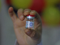 A health worker is showing a vial of polio vaccine at a health center in Srinagar, Kashmir, India, on March 3, 2024. A three-day pulse polio...