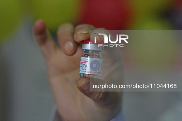 A health worker is showing a vial of polio vaccine at a health center in Srinagar, Kashmir, India, on March 3, 2024. A three-day pulse polio...