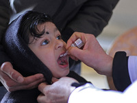 A health worker is administering polio vaccine drops to a child in Srinagar, Kashmir, India, on March 3, 2024. A three-day pulse polio vacci...