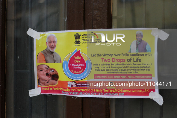 A poster is being pasted outside the health center in Srinagar, Kashmir, India, on March 3, 2024. A three-day pulse polio vaccination drive...