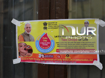 A poster is being pasted outside the health center in Srinagar, Kashmir, India, on March 3, 2024. A three-day pulse polio vaccination drive...