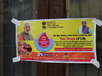 A poster is being pasted outside the health center in Srinagar, Kashmir, India, on March 3, 2024. A three-day pulse polio vaccination drive...