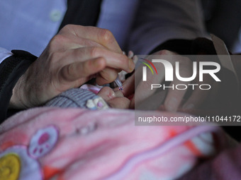 A health worker is administering polio vaccine drops to a child in Srinagar, Kashmir, India, on March 3, 2024. A three-day pulse polio vacci...