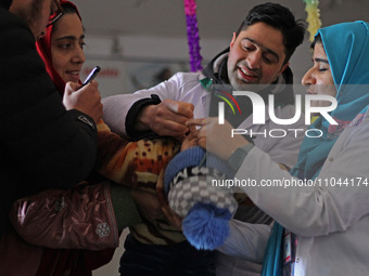 Health workers are administering polio vaccine drops to a child in Srinagar, Kashmir, India, on March 3, 2024. A three-day pulse polio vacci...