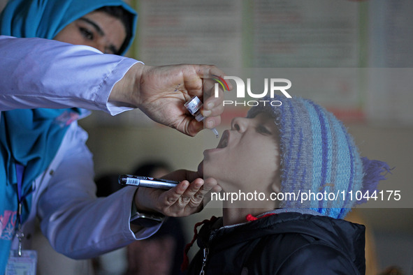 A health worker is administering polio vaccine drops to a child in Srinagar, Kashmir, India, on March 3, 2024. A three-day pulse polio vacci...