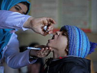 A health worker is administering polio vaccine drops to a child in Srinagar, Kashmir, India, on March 3, 2024. A three-day pulse polio vacci...