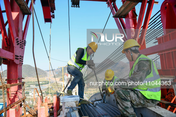 Workers are working at the construction site of Jinzhou Bridge in Xingyi City, Qiandinan Buyi and Miao Autonomous Prefecture, Guizhou Provin...