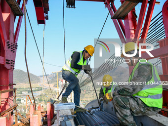 Workers are working at the construction site of Jinzhou Bridge in Xingyi City, Qiandinan Buyi and Miao Autonomous Prefecture, Guizhou Provin...