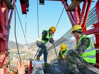 Workers are working at the construction site of Jinzhou Bridge in Xingyi City, Qiandinan Buyi and Miao Autonomous Prefecture, Guizhou Provin...