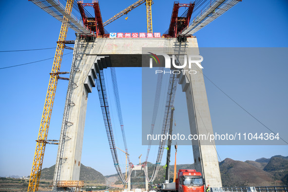 Workers are working at the construction site of Jinzhou Bridge in Xingyi City, Qiandinan Buyi and Miao Autonomous Prefecture, Guizhou Provin...