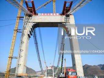 Workers are working at the construction site of Jinzhou Bridge in Xingyi City, Qiandinan Buyi and Miao Autonomous Prefecture, Guizhou Provin...