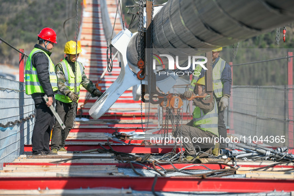 Workers are working at the construction site of Jinzhou Bridge in Xingyi City, Qiandinan Buyi and Miao Autonomous Prefecture, Guizhou Provin...