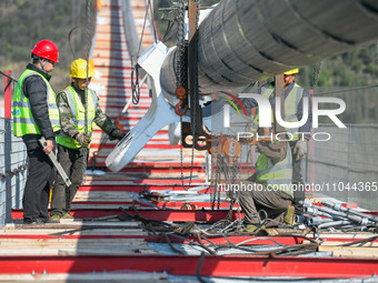 Workers are working at the construction site of Jinzhou Bridge in Xingyi City, Qiandinan Buyi and Miao Autonomous Prefecture, Guizhou Provin...