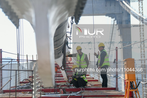 Workers are working at the construction site of Jinzhou Bridge in Xingyi City, Qiandinan Buyi and Miao Autonomous Prefecture, Guizhou Provin...